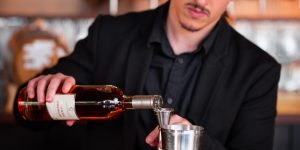 Photo of bartender pouring Cognac into a jigger.