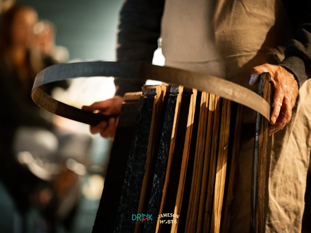 Close-up photo of man building a whiskey barrel at the Jameson Hosts event.